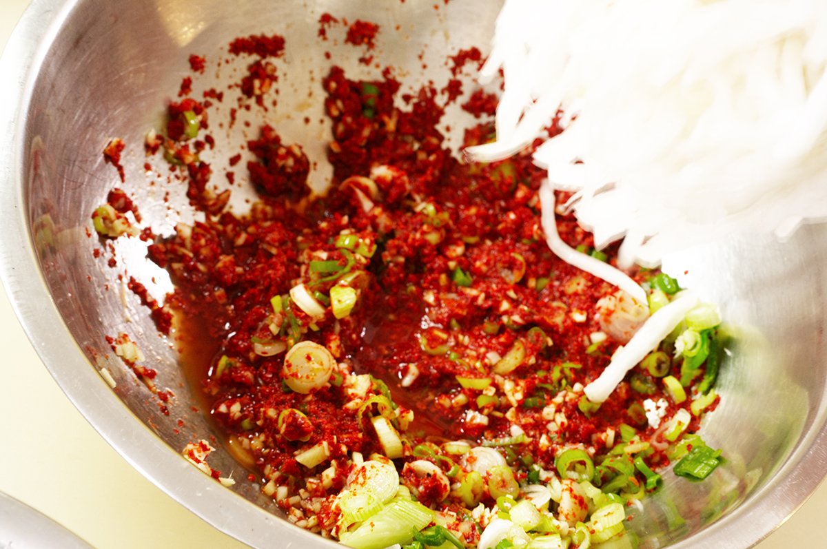 adding radish to kimchi brine
