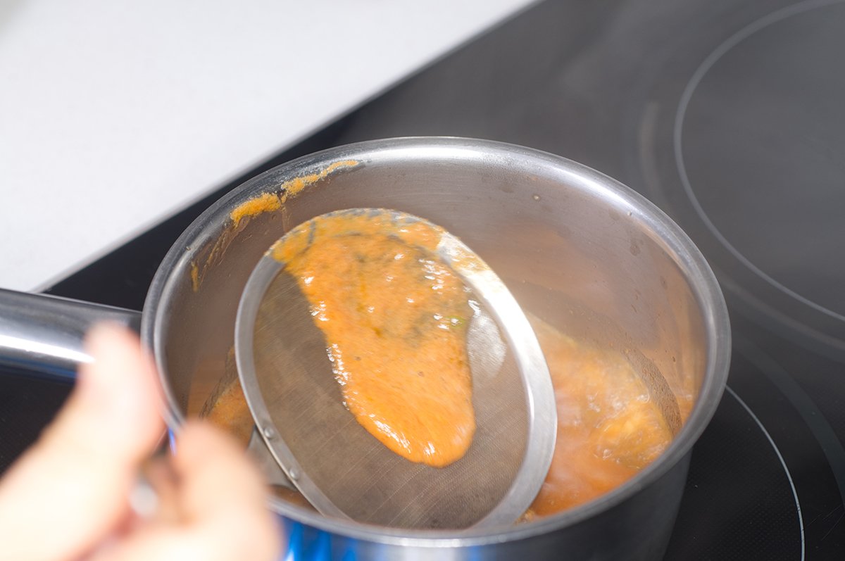 skimming the impurities from the marinade as it heats