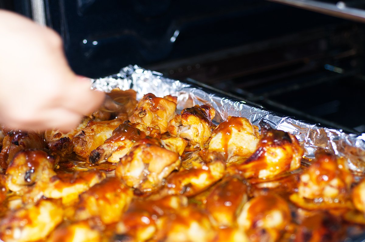 putting wings on foil lined baking sheet