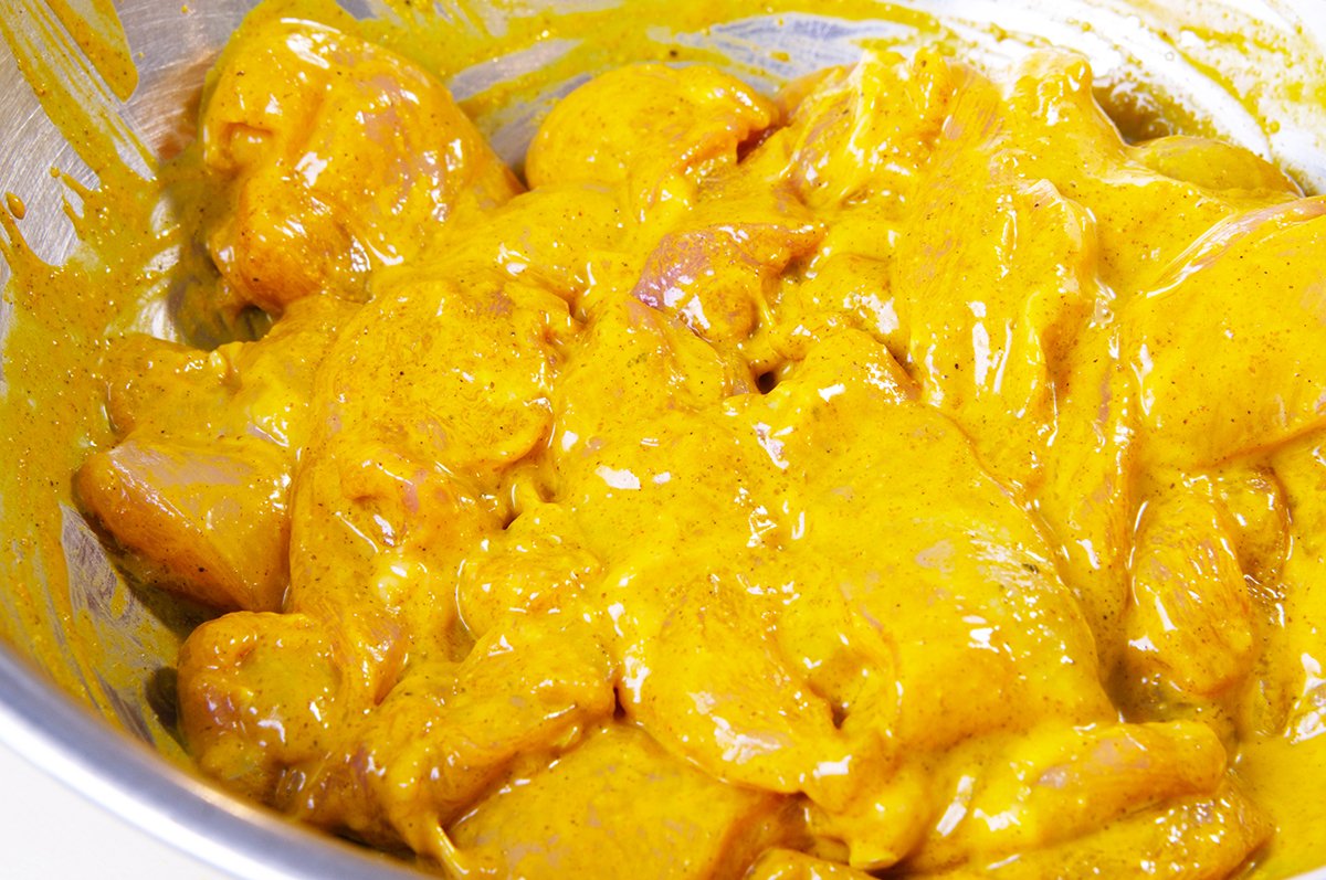 making sure all chicken is coated with marinade