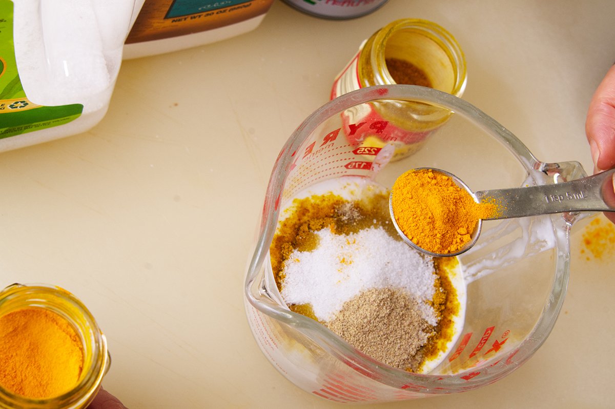 adding spices to the marinade for chicken satay