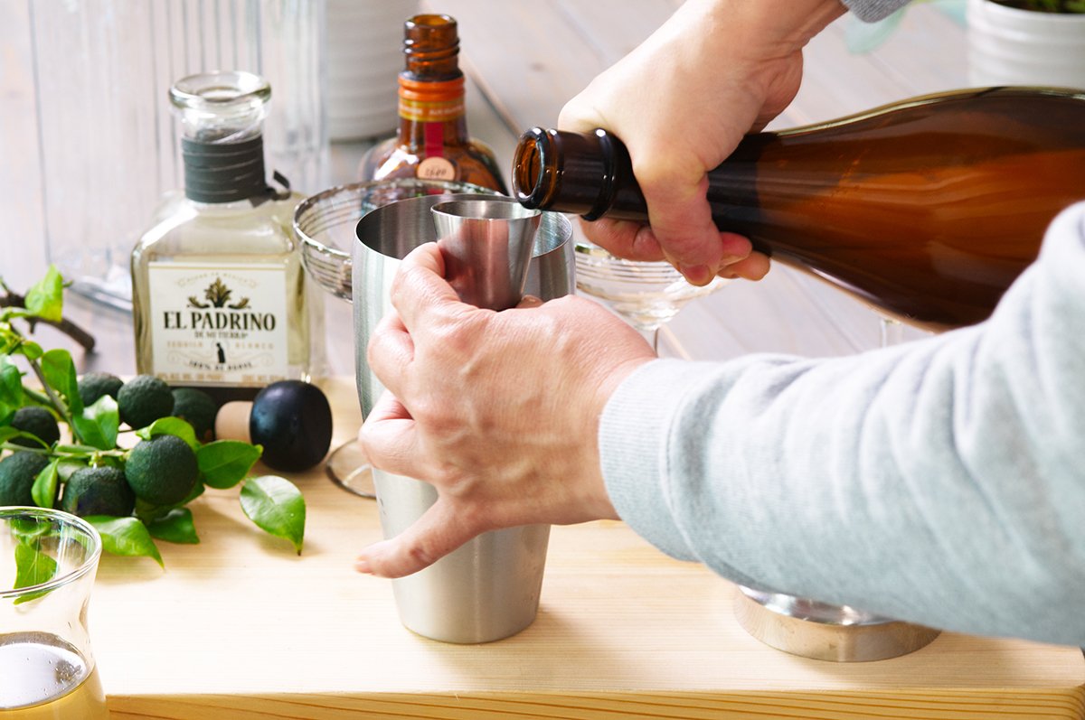 pouring juice for yuzu margaritas
