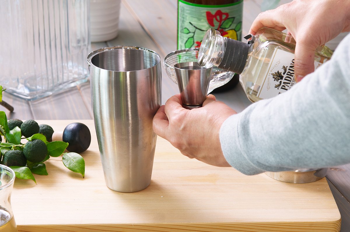 adding tequila to yuzu margarita