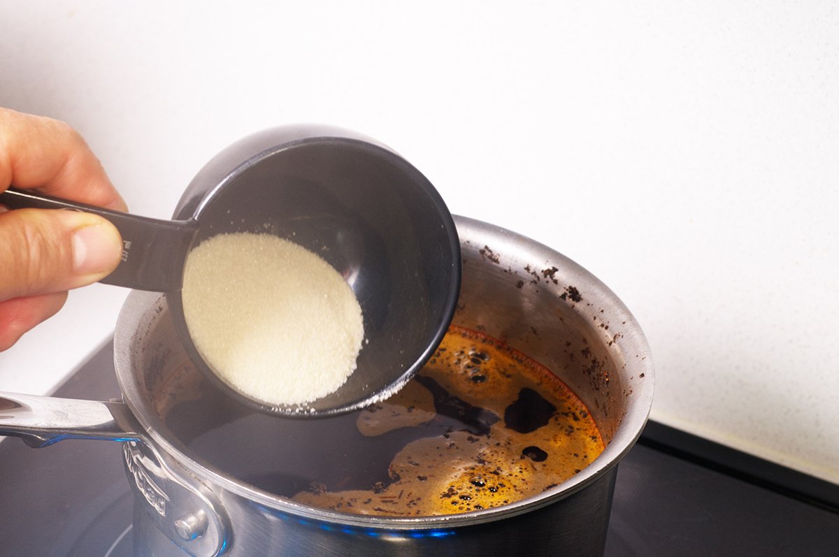 adding sugar to tea