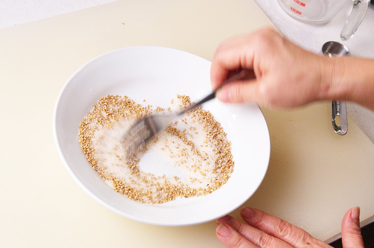mixing sesame and sugar for palitaw