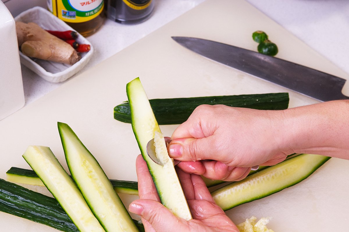 spooning out cucumber seeds