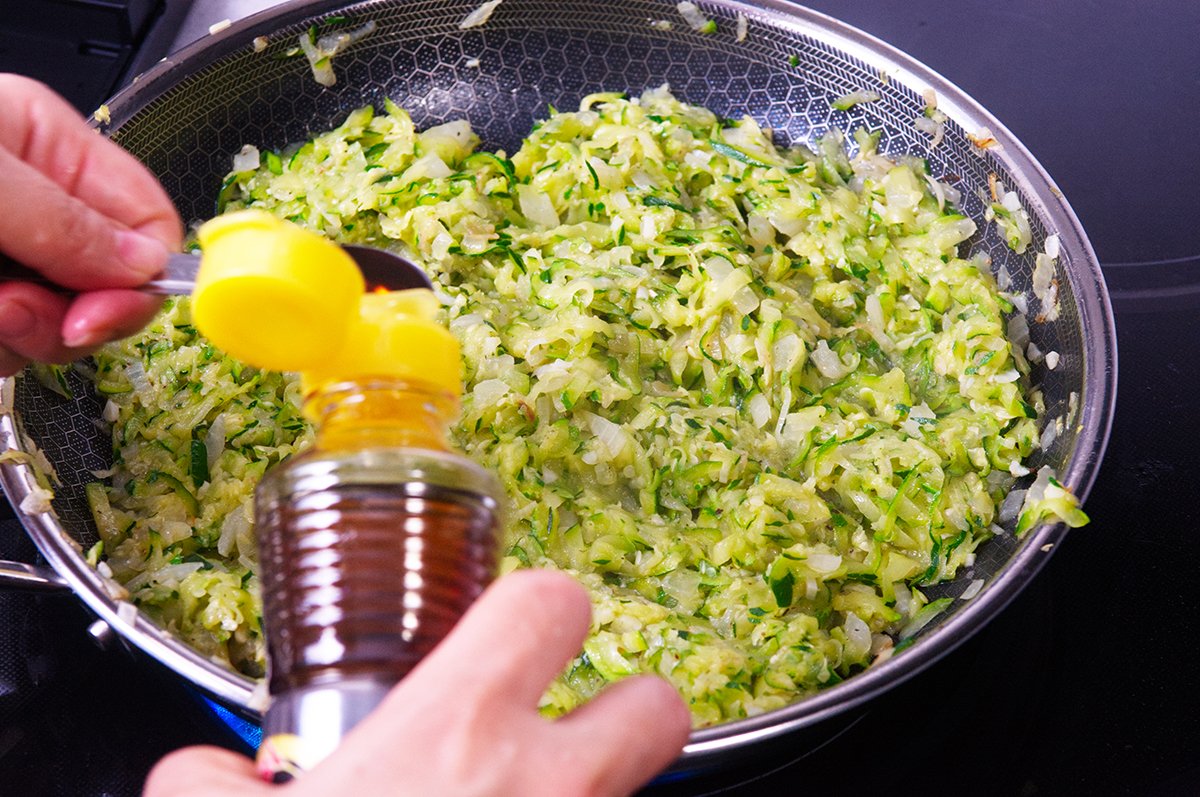pouring sesame oil into zucchini jam