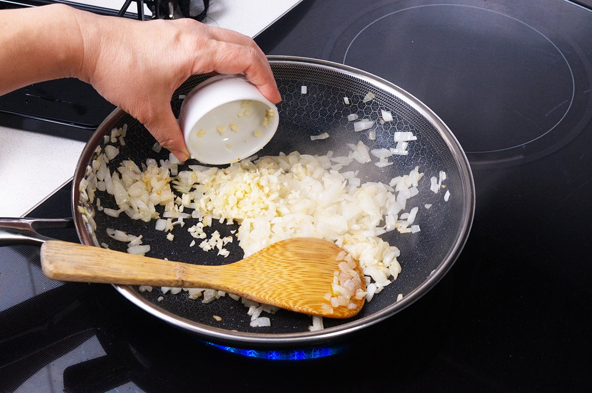 adding garlic to zucchini jam
