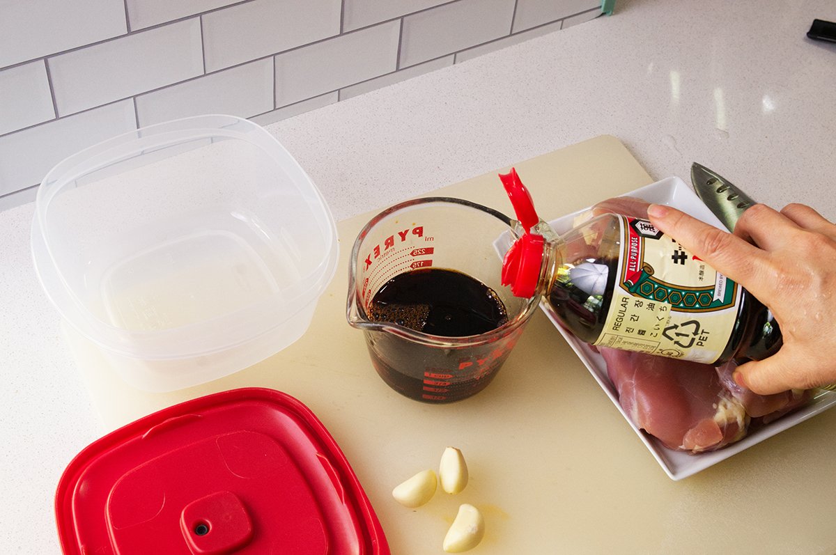 measuring soy sauce for mom's chicken