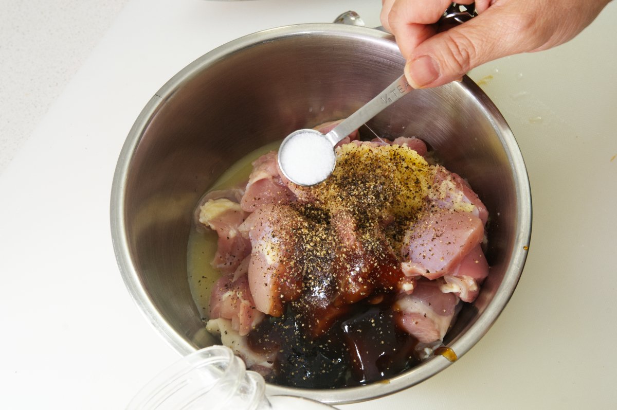 adding seasonings to Japanese fried chicken