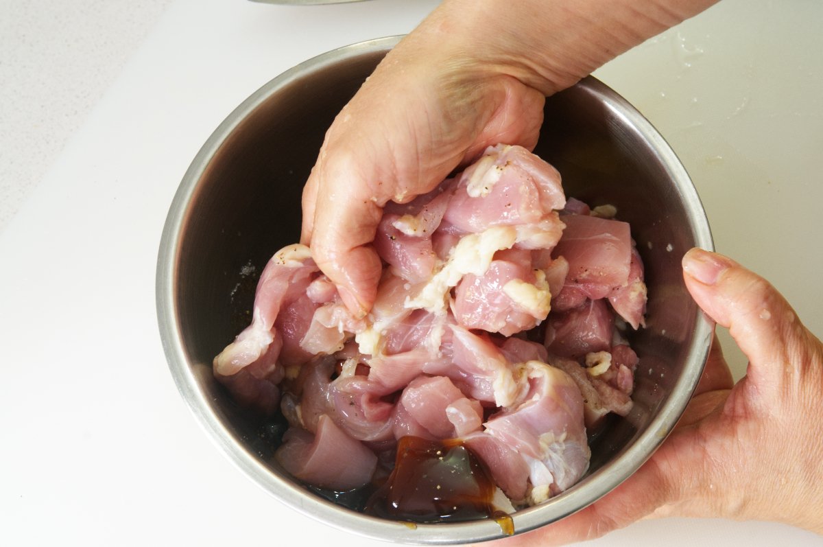 mixing in seasoning to Japanese fried chicken