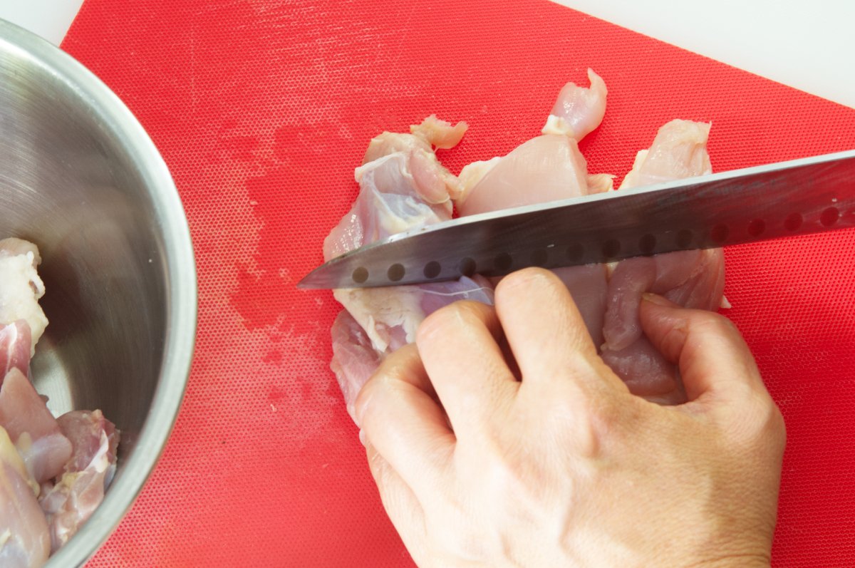 cutting thighs into chunks for japanese fried chicken