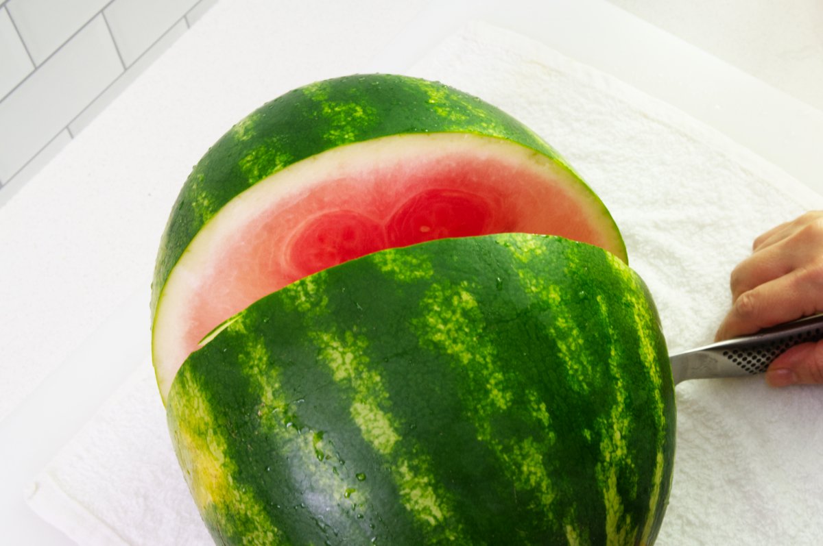 cutting melon in half for watermelon soju