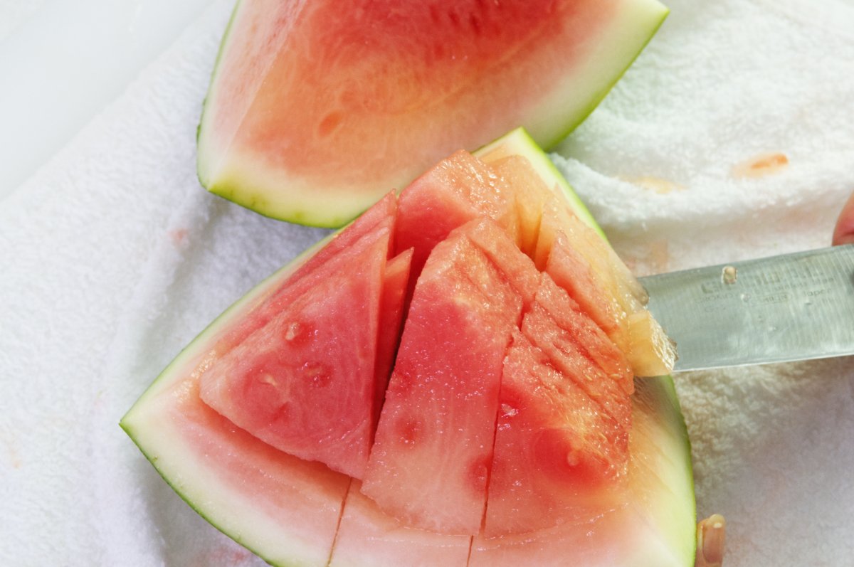 cutting fruit into chunks for watermelon soju