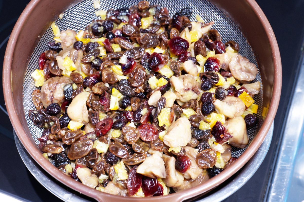 straining out the dried fruit for pound cake