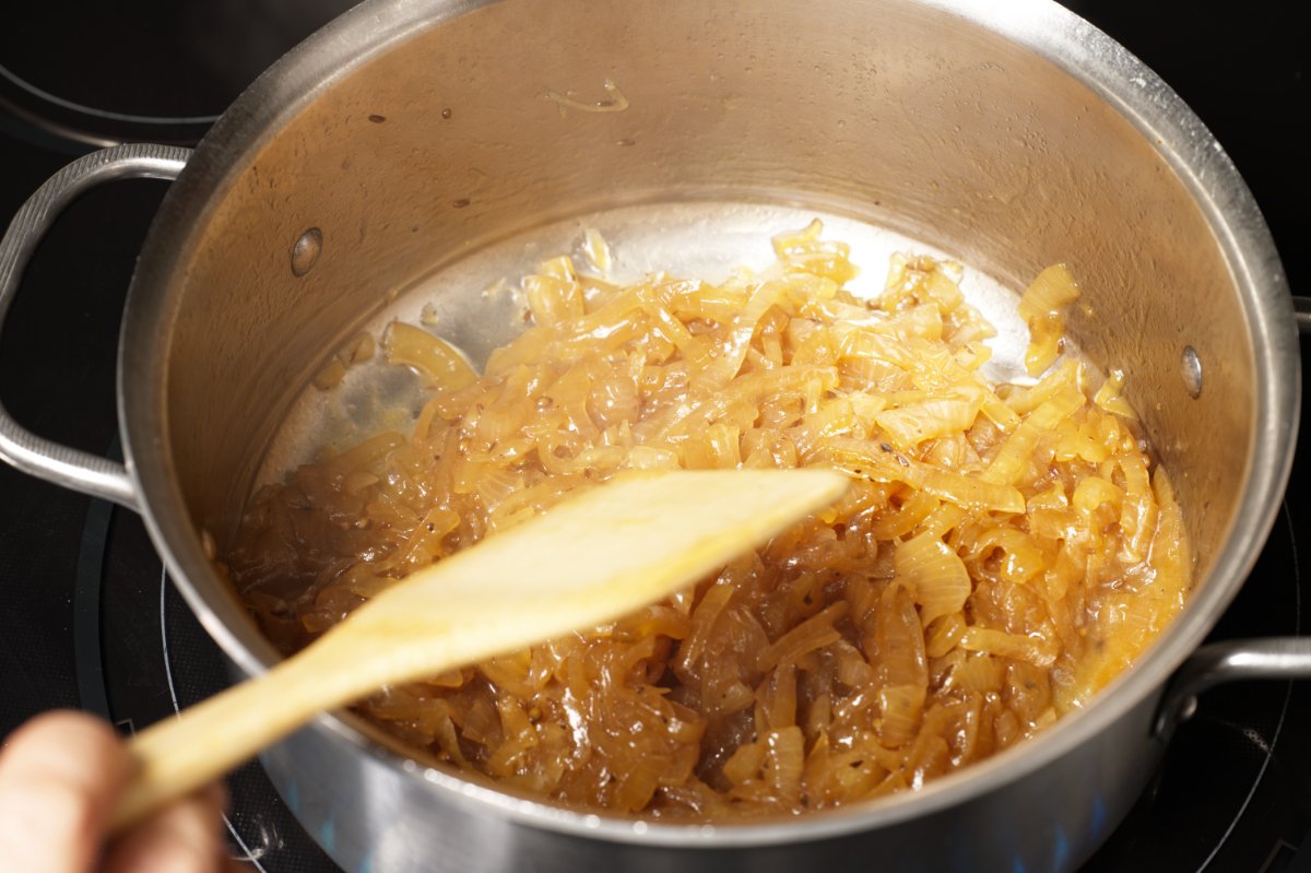 wooden spoon stirring the onion jam