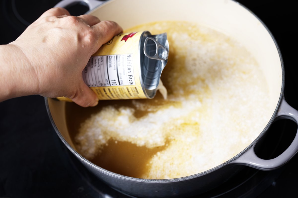adding coconut milk to strained broth