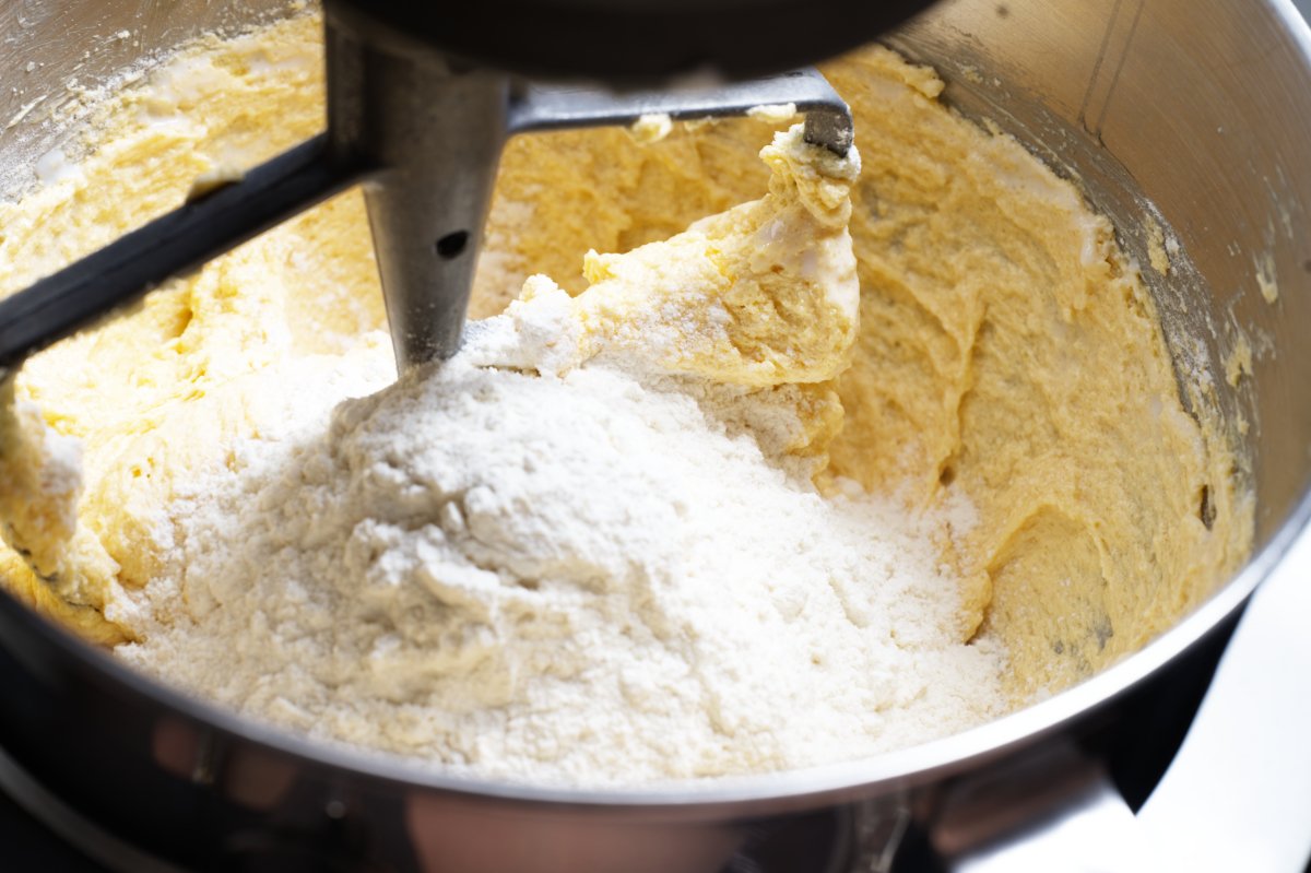 adding flour to the cake batter