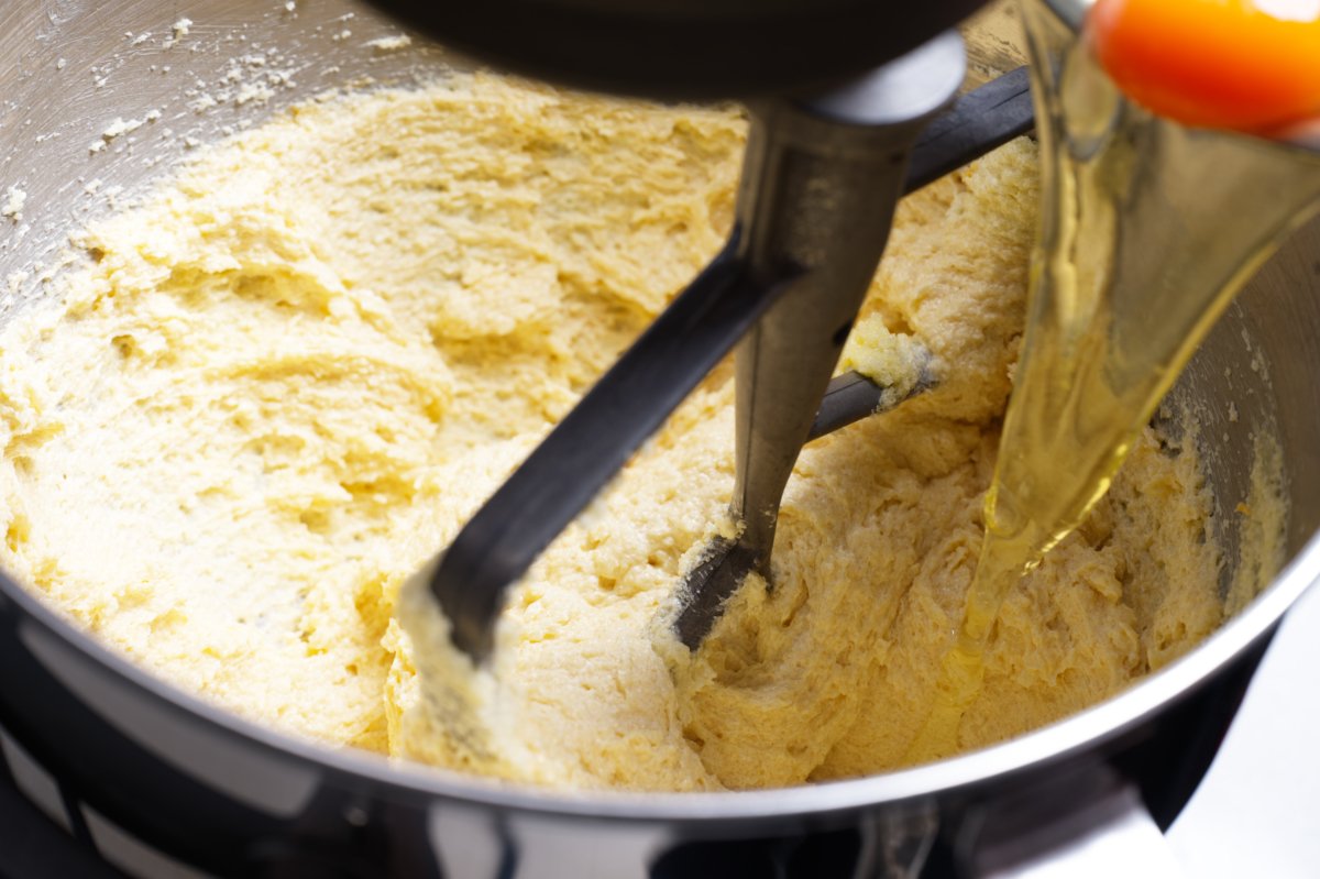 adding egg to lemon cake batter