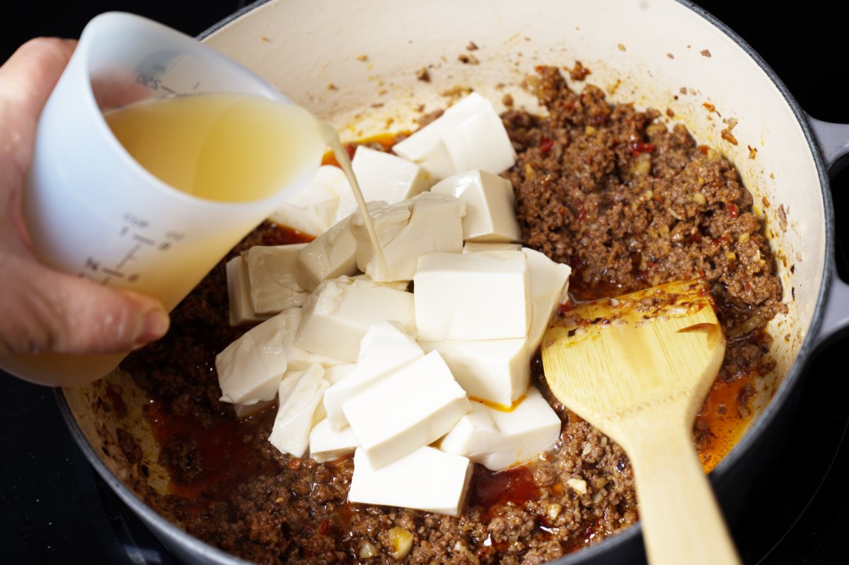 adding chicken broth