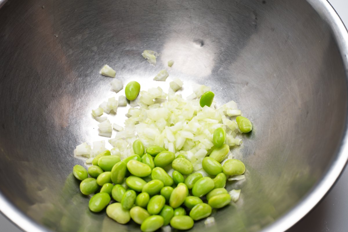 edamame and celery in a bowl