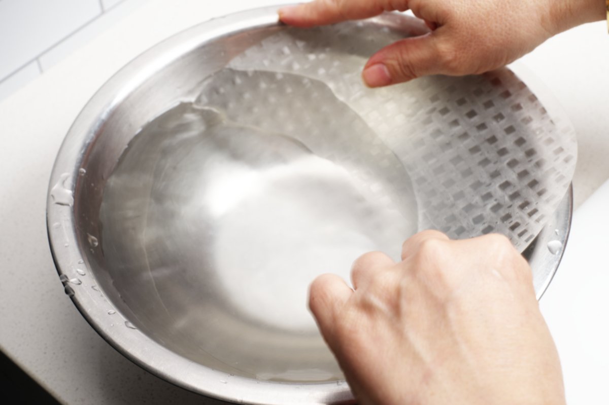 softening rice paper in water for shrimp dumplings