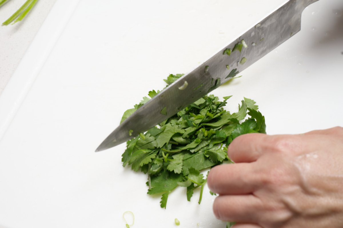 cutting herbs for crispy shrimp dumpling 