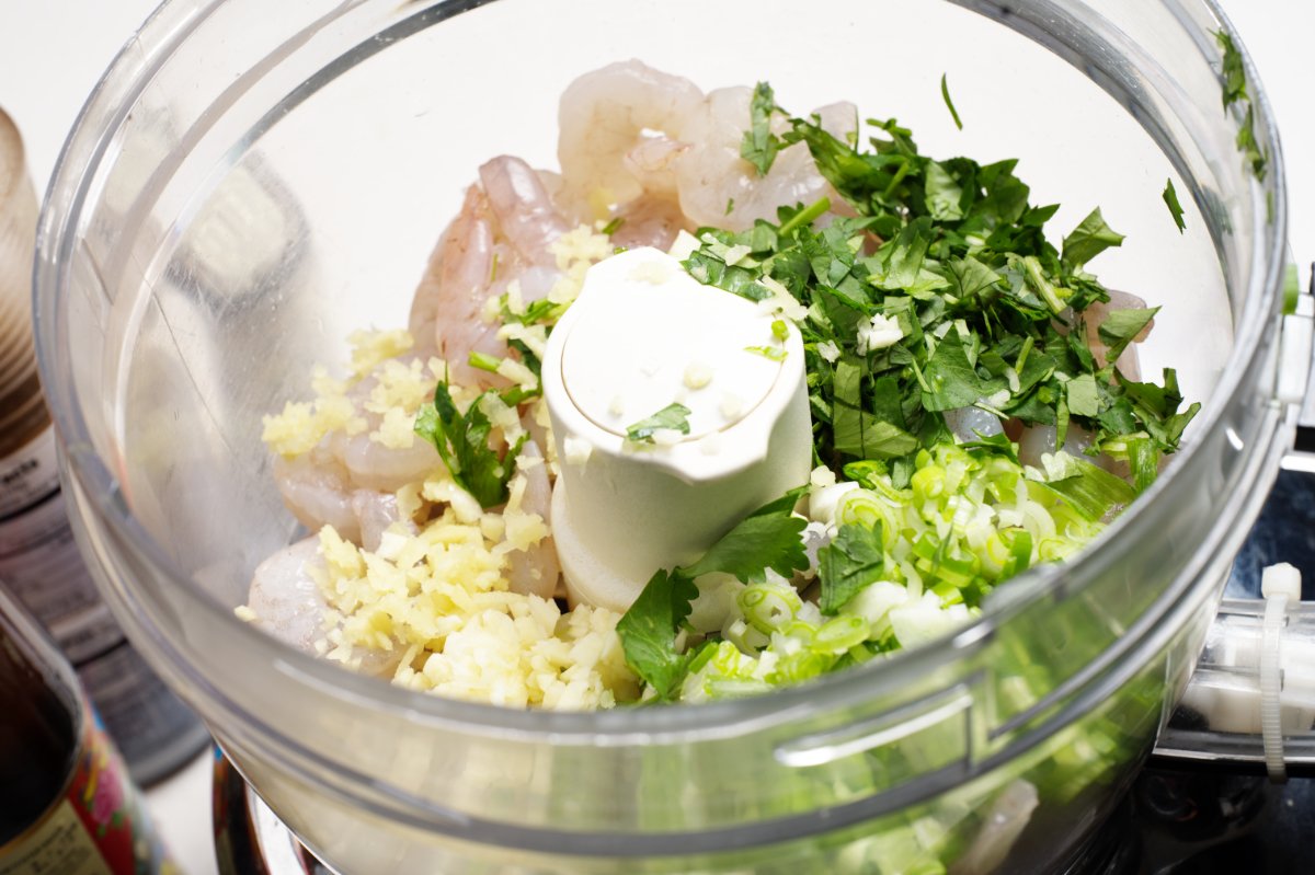 adding ingredients to processor crispy shrimp dumplings