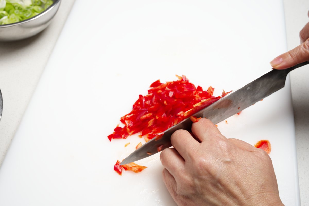 cutting red pepper for caramelized beef fried rice