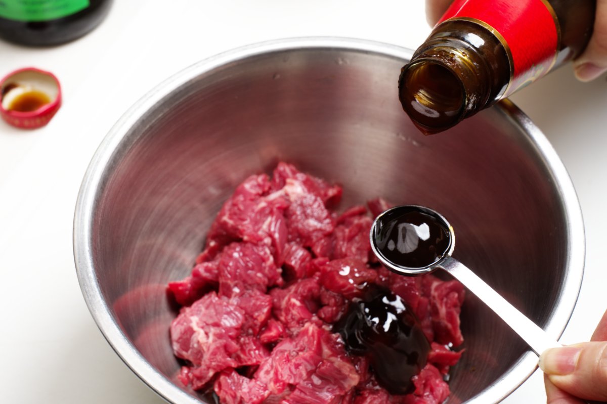 adding oyster sauce caramelized beef fried rice