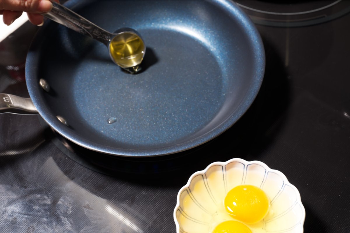 heating oil in a pan to fry the eggs