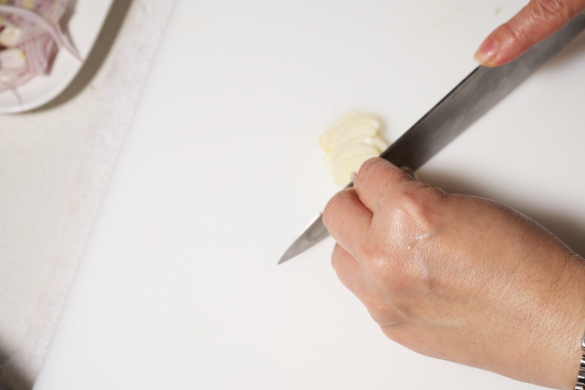 thinly slicing the garlic