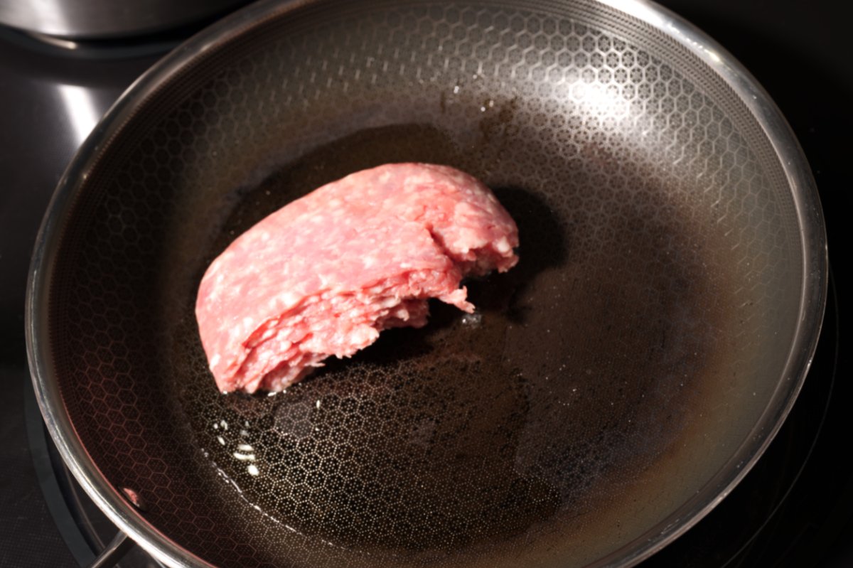 adding the pork to the pan dan dan