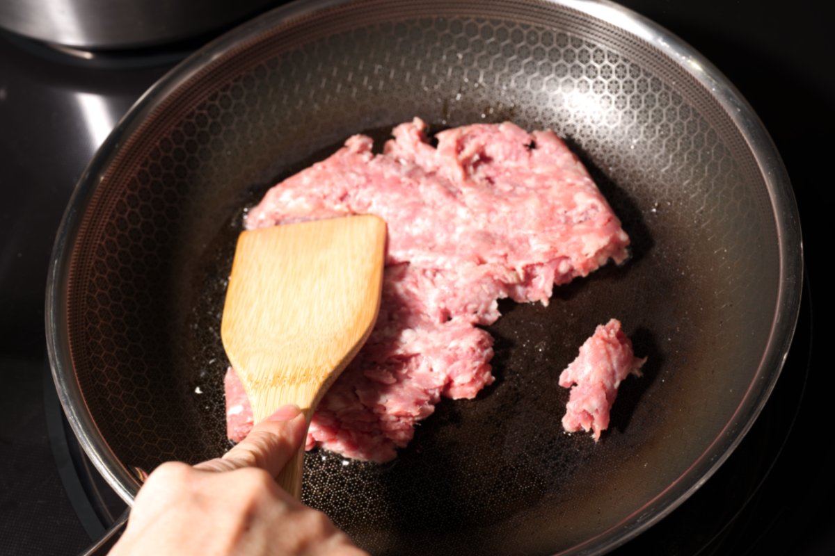 pressing meat down with spatula