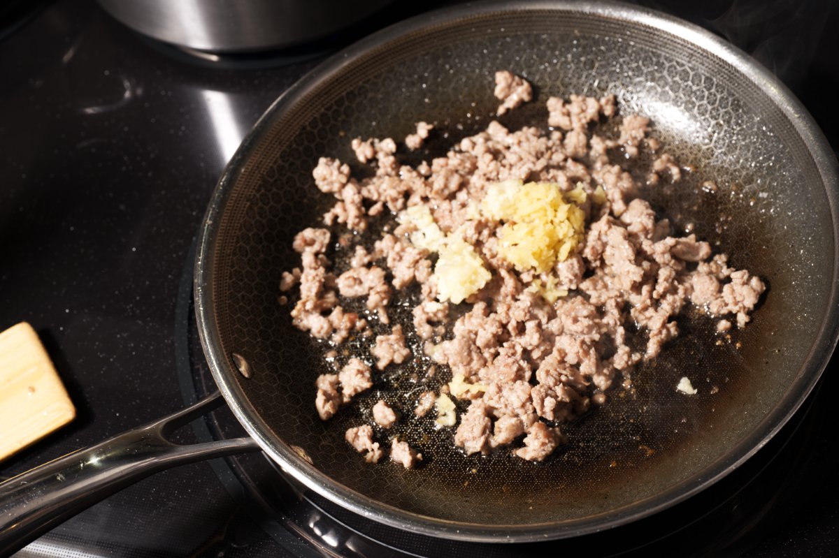adding the ginger and garlic dan dan noodles