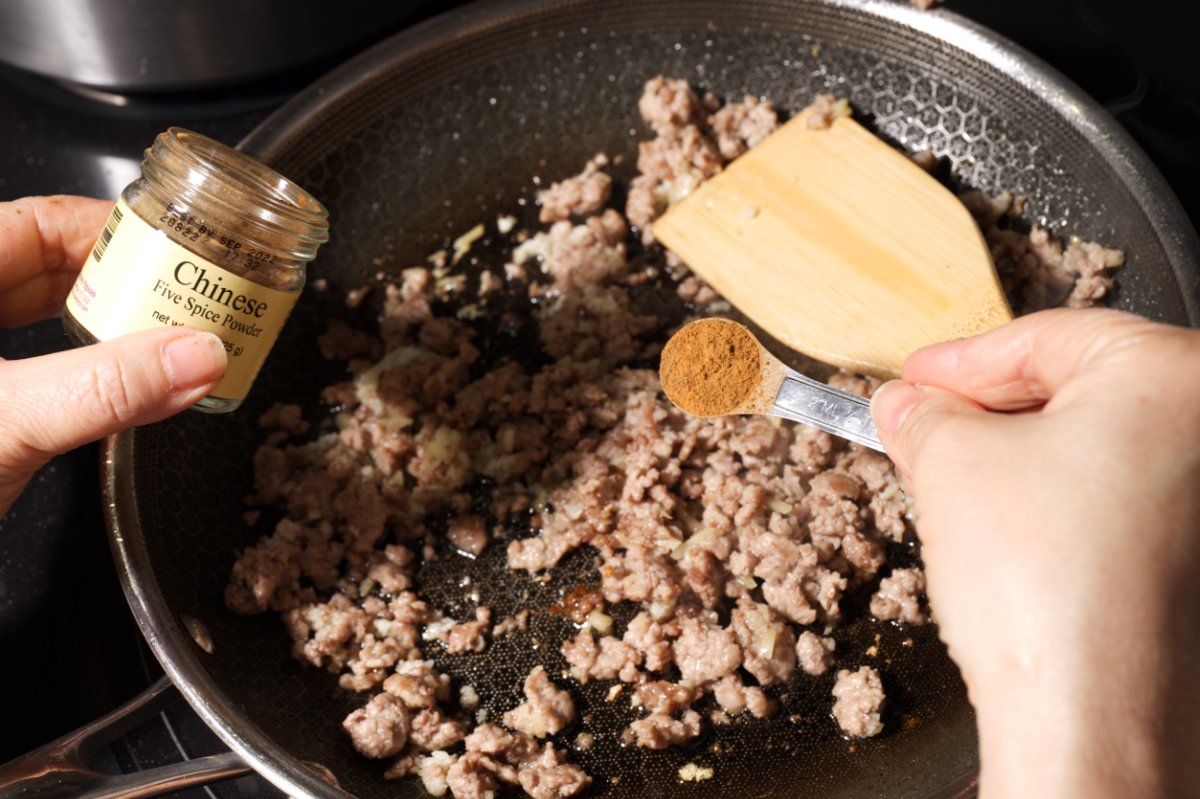 adding 5 spice powder to pork