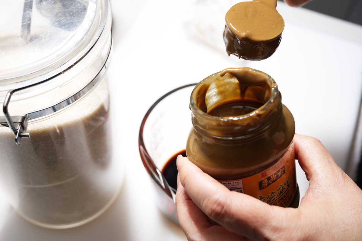 adding the sesame paste to the dan dan sauce