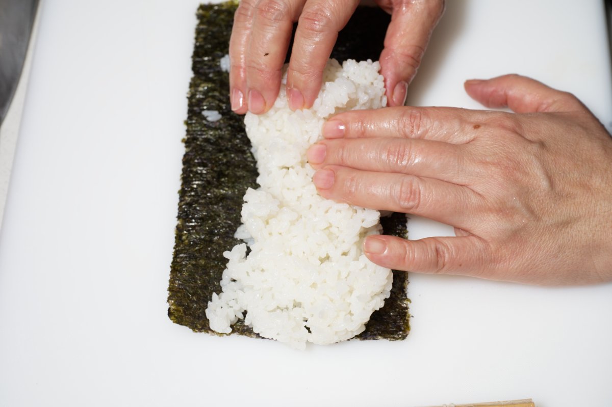 putting rice on top of nore California rolls