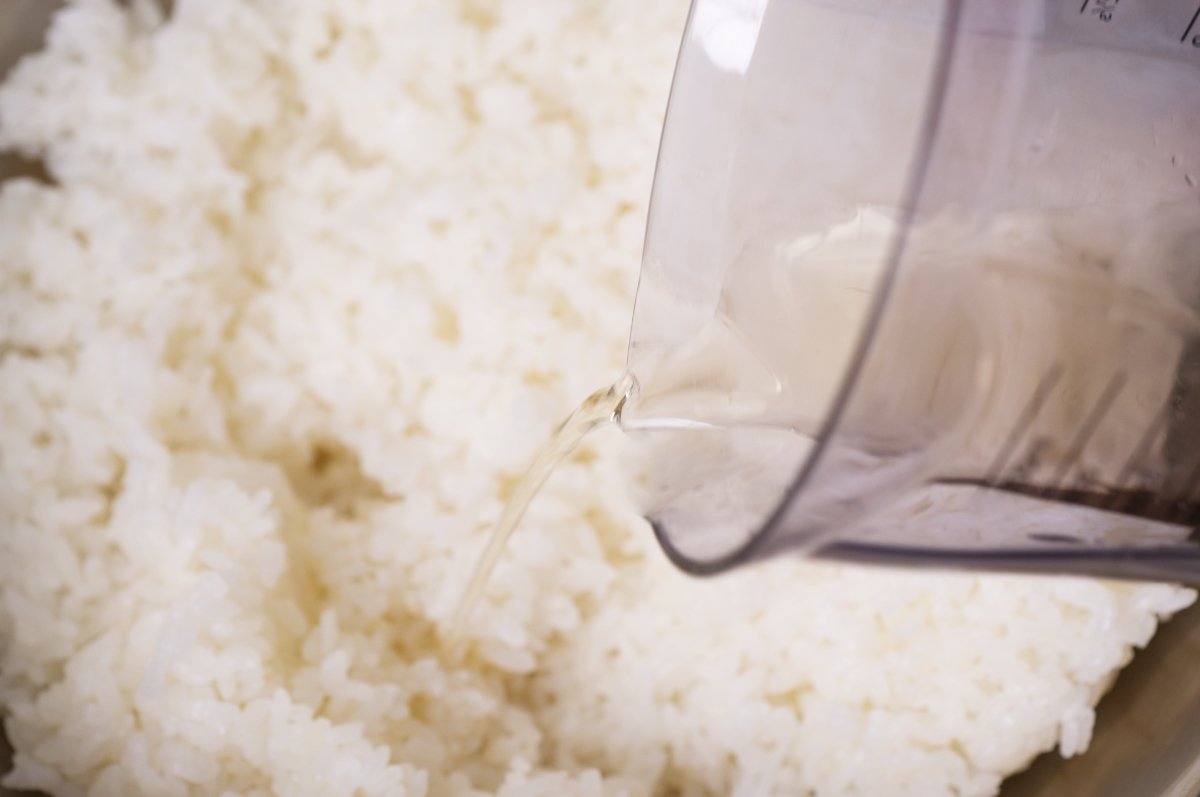 adding the sushi vinegar to the rice california rolls