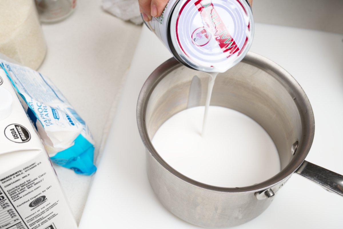 adding coconut milk to pot