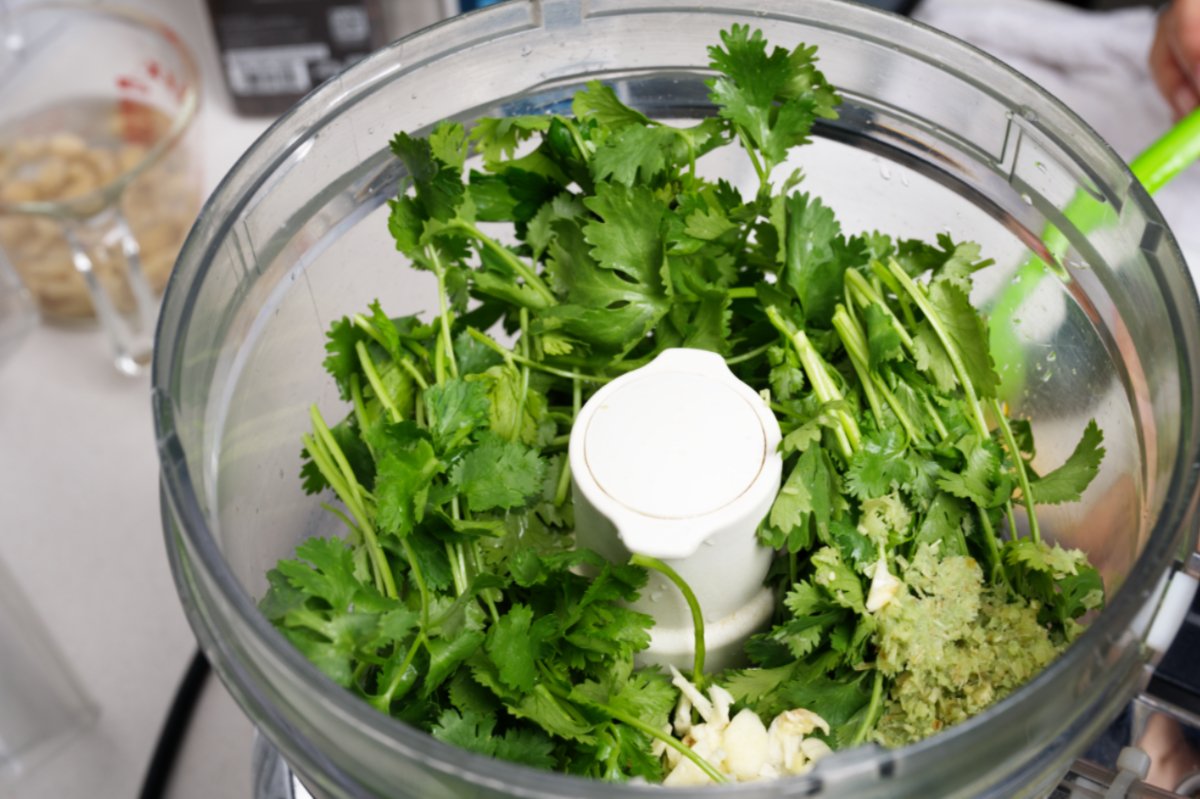 herbs in processor for chilled shrimp with asian pesto