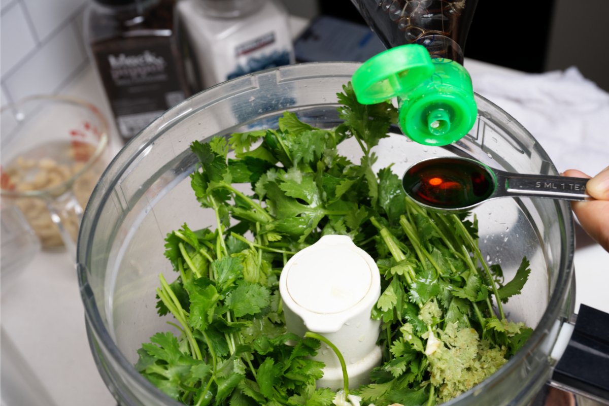 adding fish sauce to asian pesto