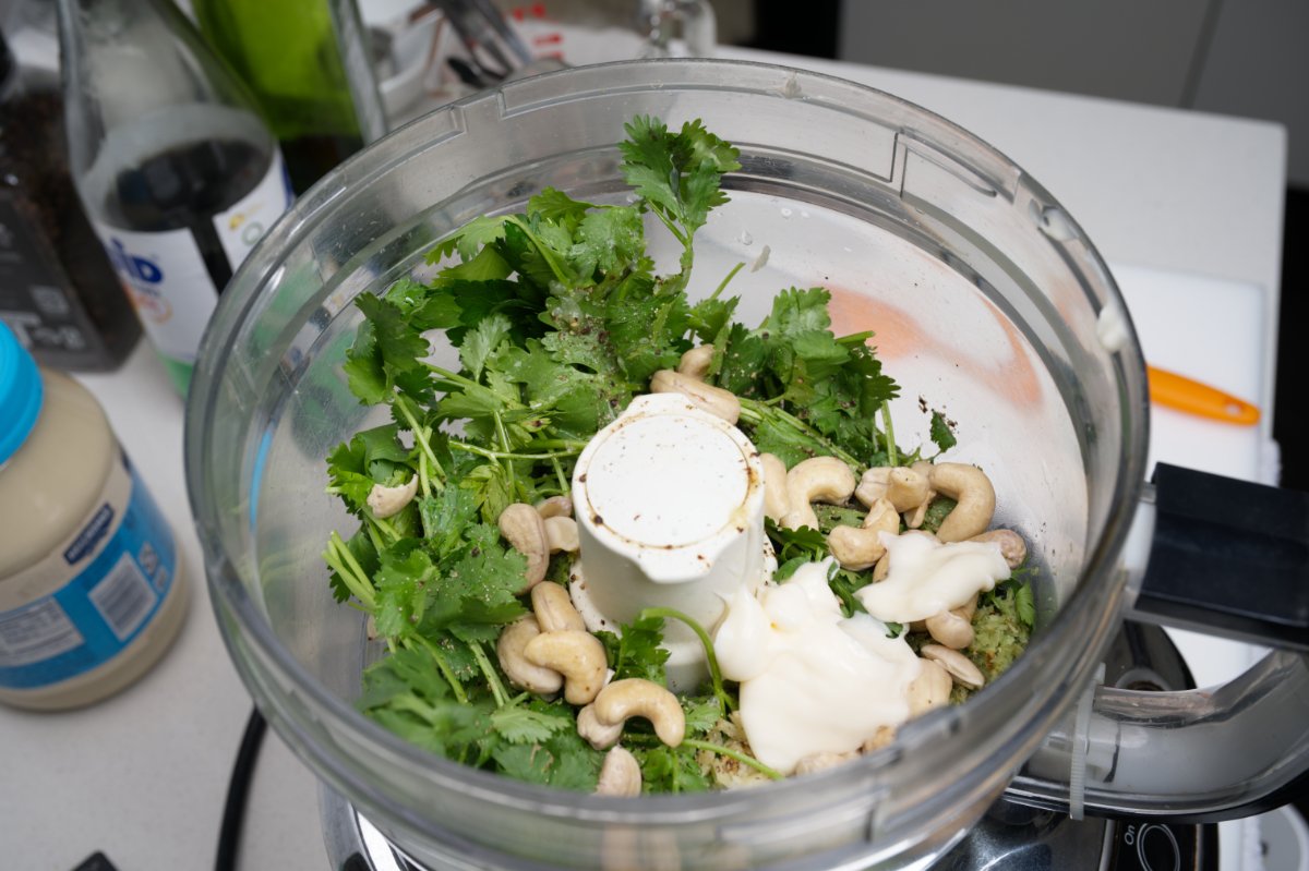 adding mayo and cashews to asian pesto