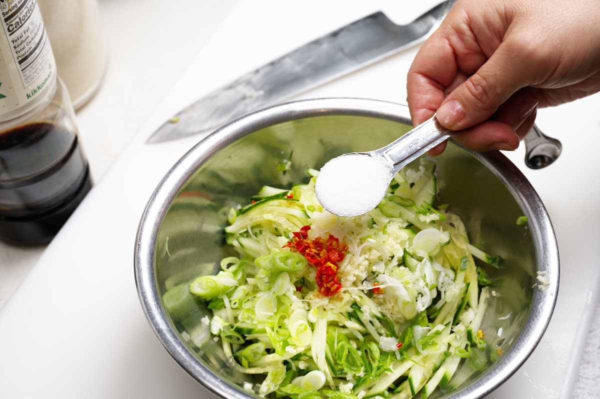 adding salt to chilled watermelon cucumber soup