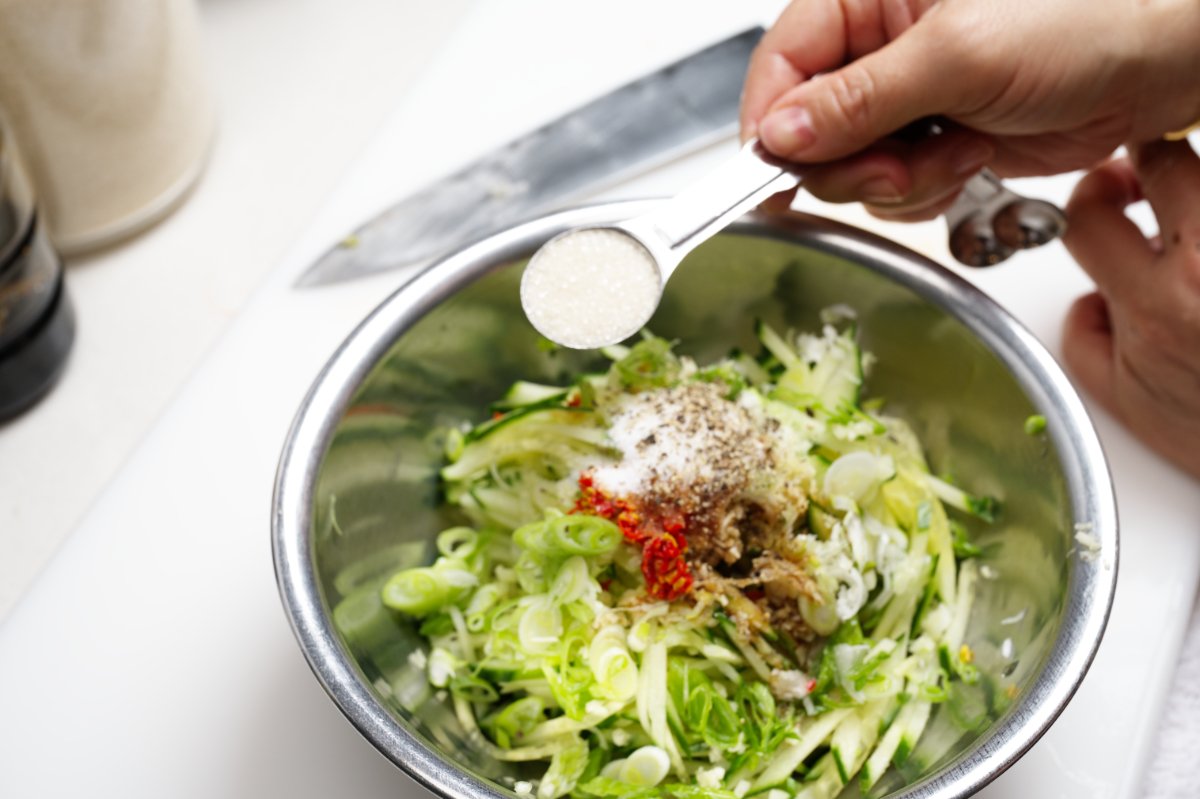 adding sugar to chilled watermelon cucumber soup