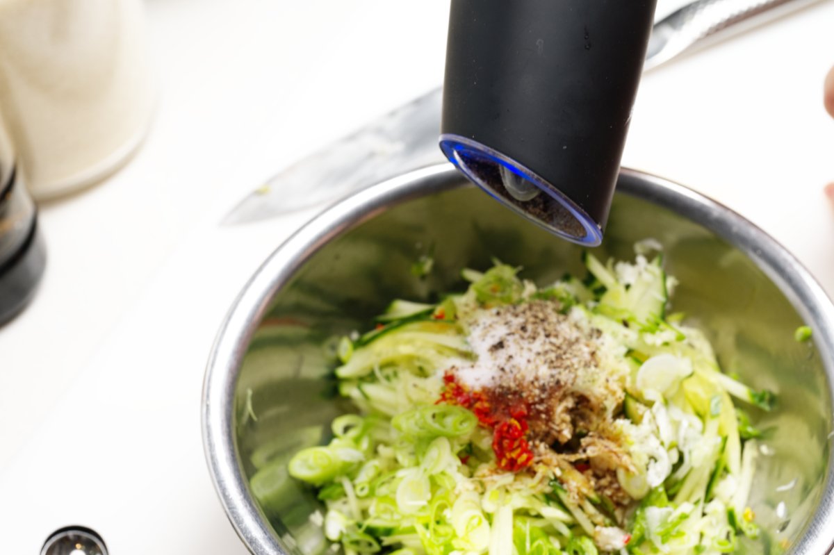 grinding fresh pepper into chilled watermelon cucumber soup