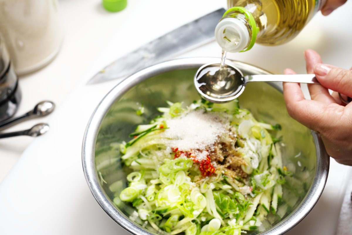 adding rice vinegar to the cucumber