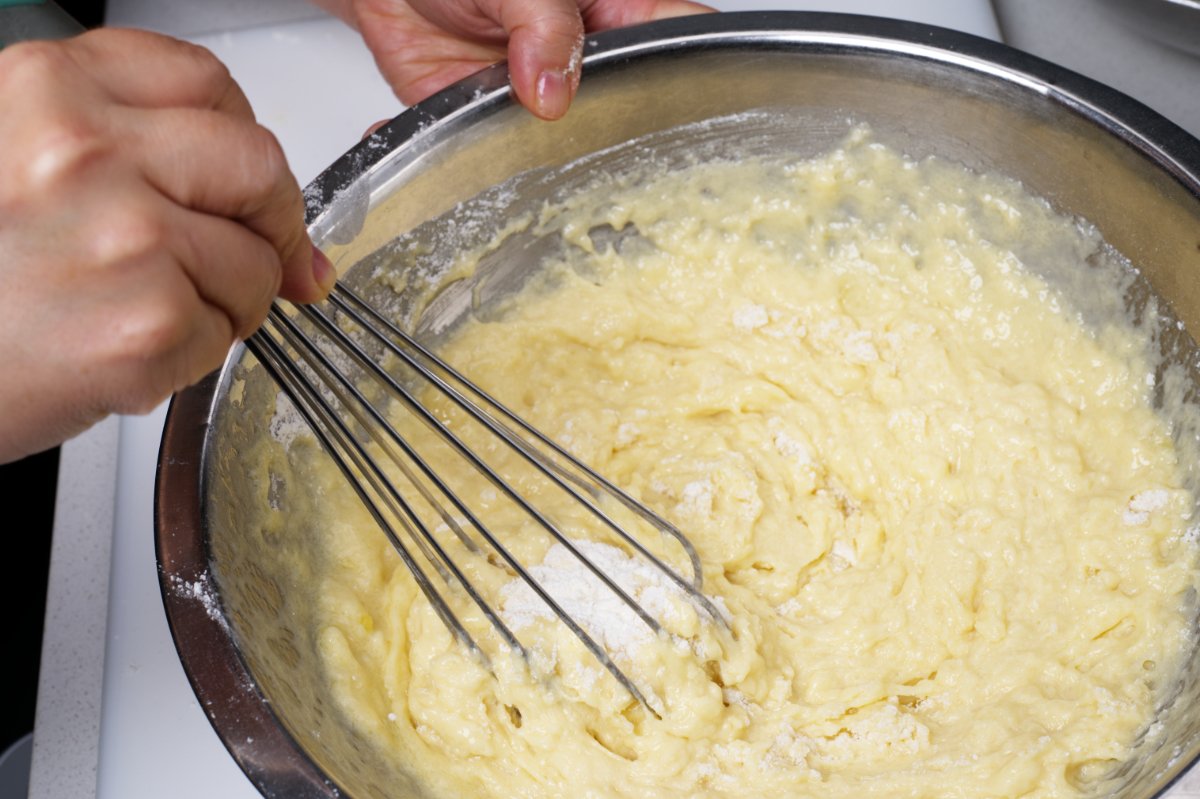 mixing batter together blueberry muffins
