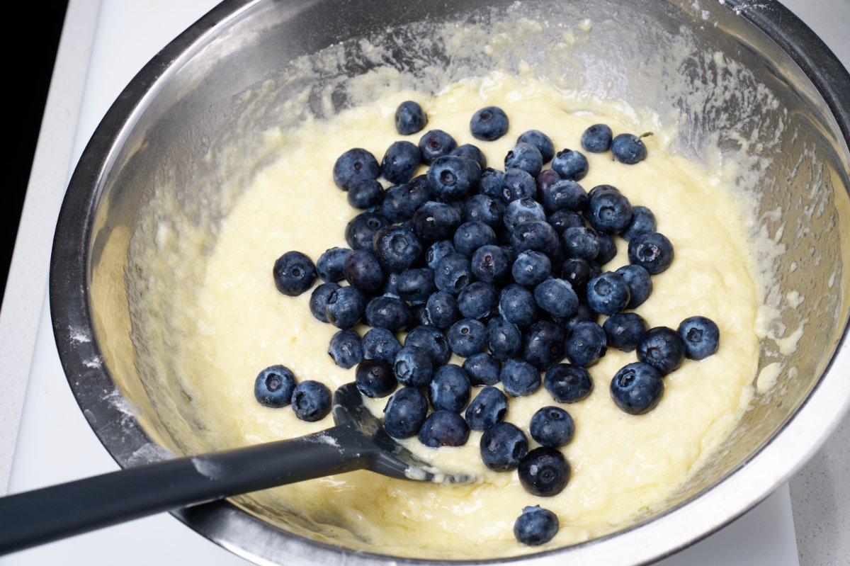 adding the blueberries to muffin batter