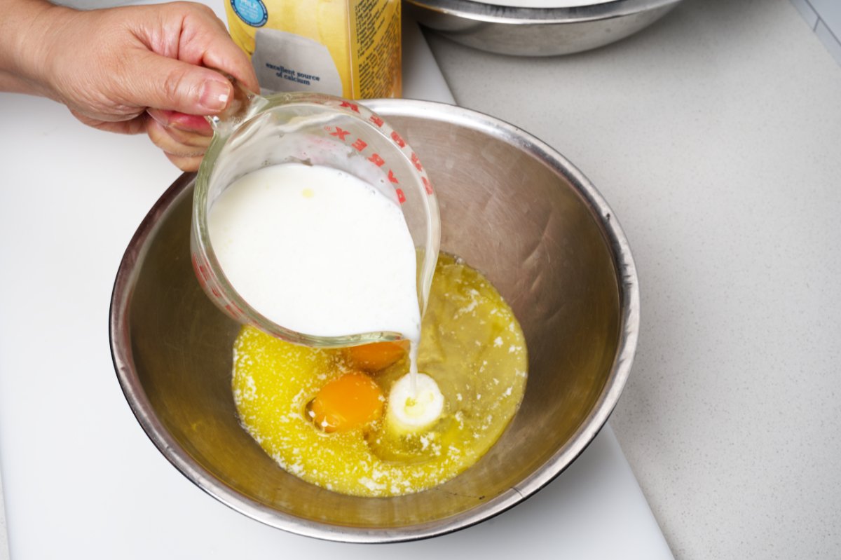 adding buttermilk to wet ingredients for blueberry muffins